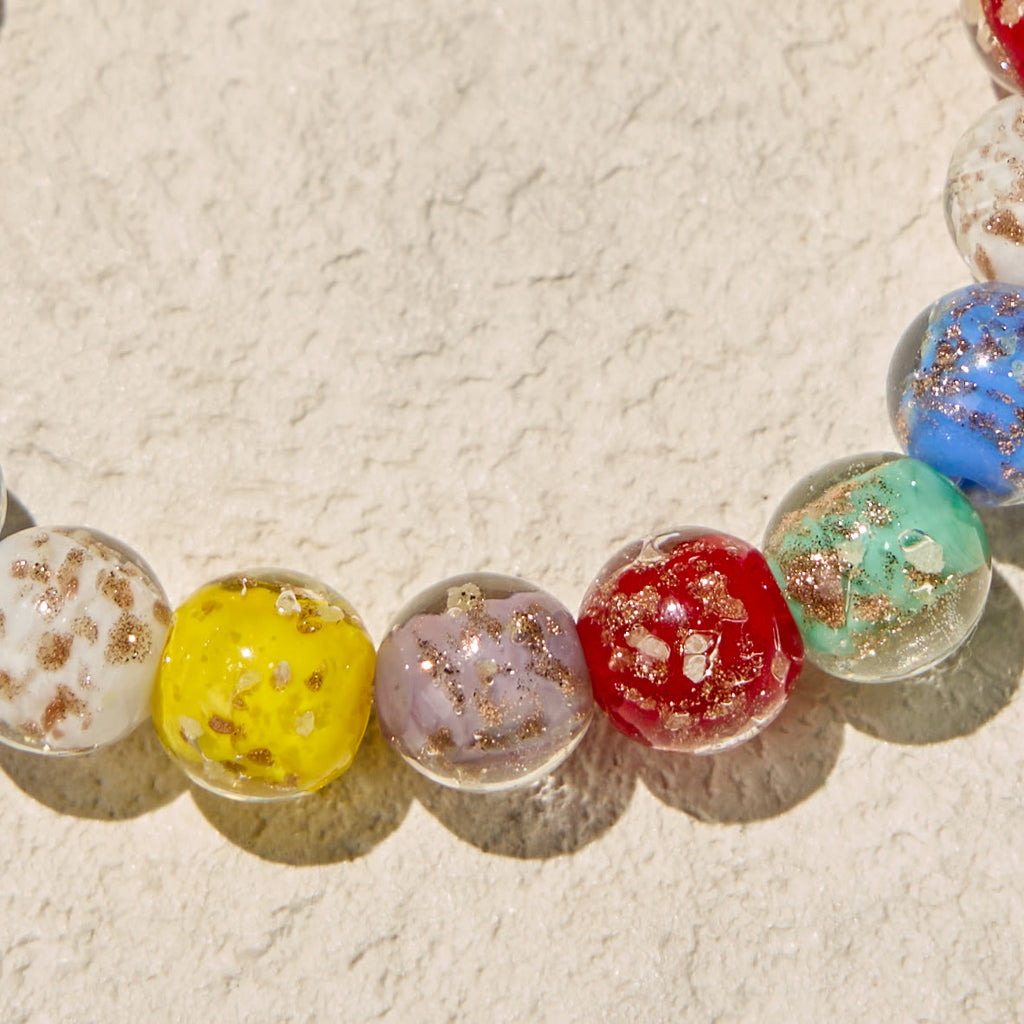 Colorful Glow-in-the-Dark Gold-Flecked Glass Bracelets with Crucifix