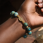 Blue oil-paint devotion bracelet worn by a woman
