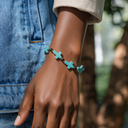 Turquoise crucifix beaded bracelet worn by a woman
