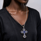Blue gemstone cross pendant necklace worn by a woman