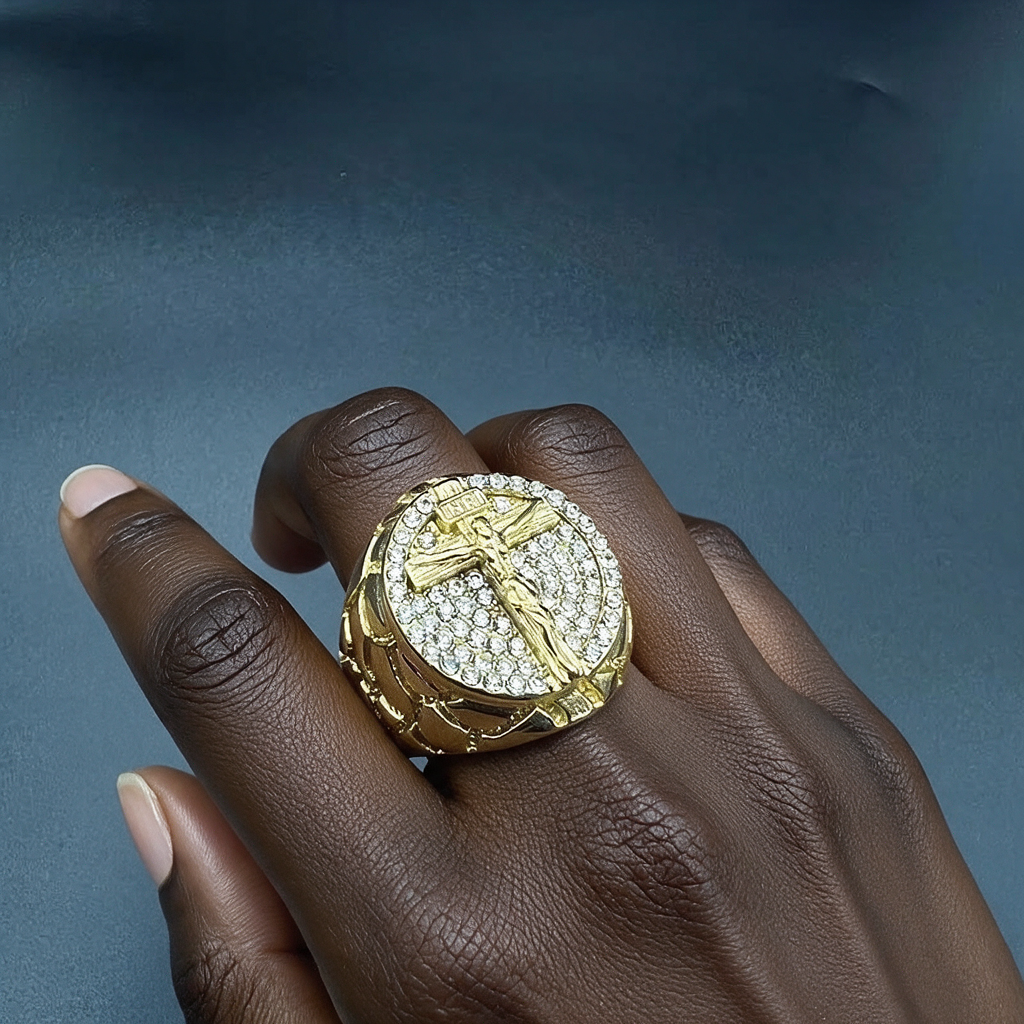 Golden pattern gemstone crucifix ring worn by a woman