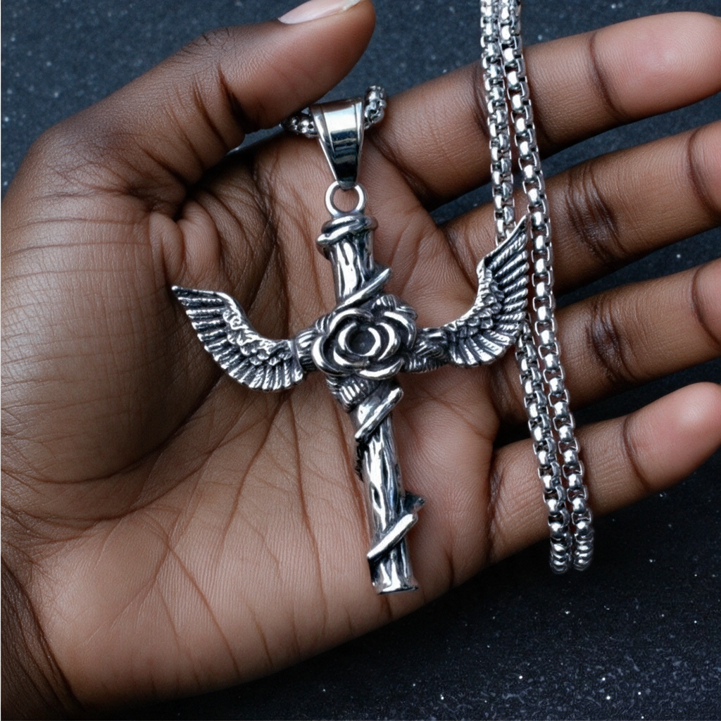 Winged rose cross pendant necklace held by a woman