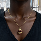 Red gemstone Sacred Heart of Jesus pendant necklace worn by a woman